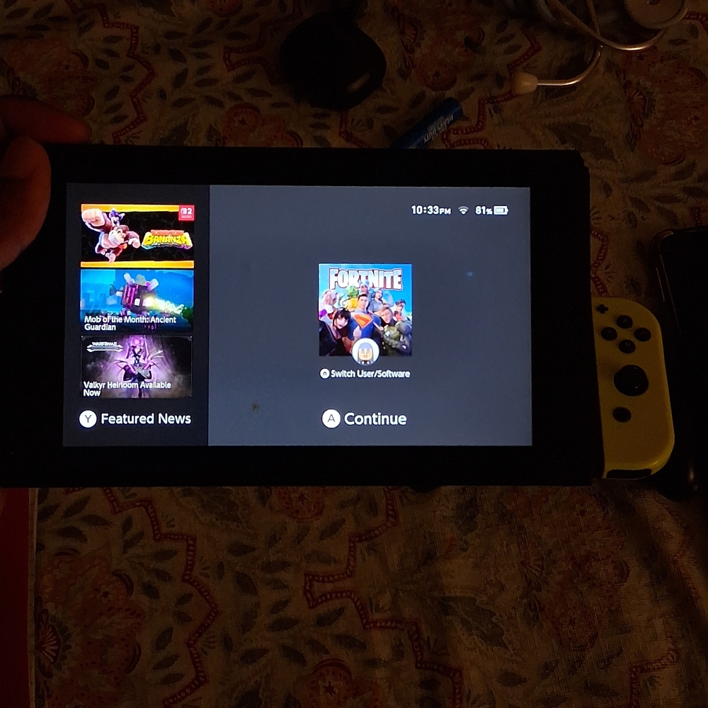 Nintendo Switch With Yellow And Purple Joycons